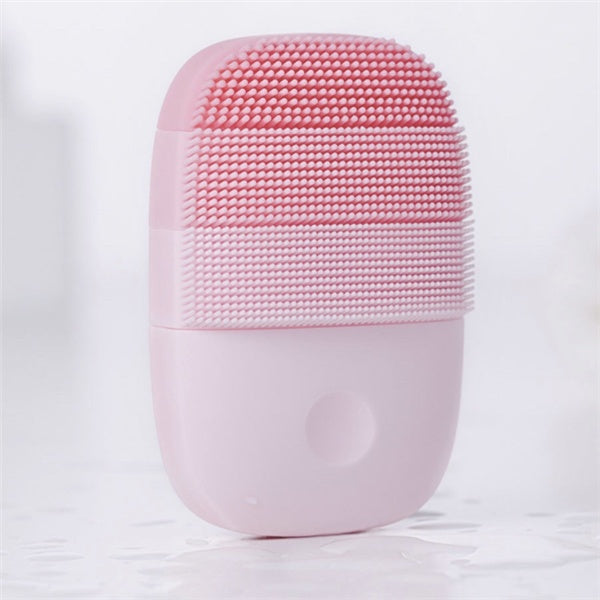 Pink ultrasonic silicone facial brush – waterproof and USB rechargeable for portable beauty.
