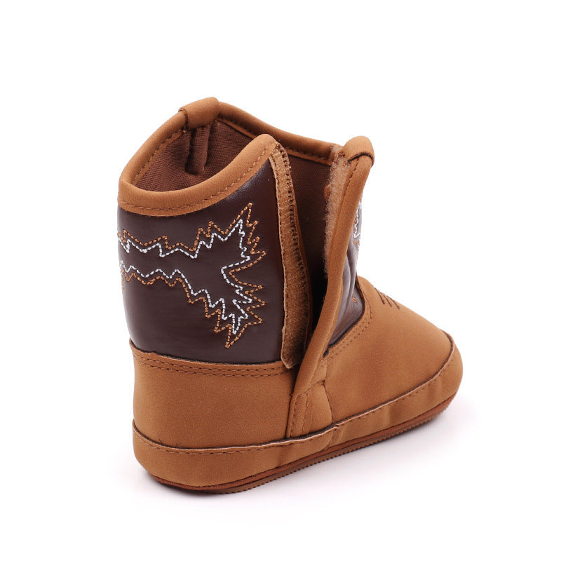 Denim-look PU leather baby boots with velcro closure and cowboy-style design, displayed on a light background a.

