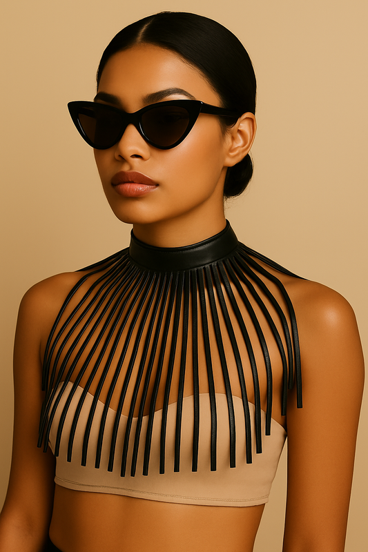 Model wearing a bold black vegan leather fringe choker necklace and cat-eye sunglasses against a beige background, styled with elegance and minimalism.
