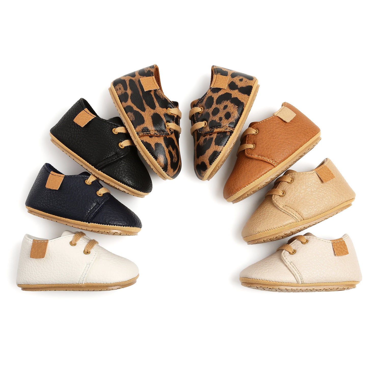 "Assorted baby moccasins in a circular layout, featuring soft leather shoes in black, navy blue, leopard print, tan, beige, and white. Anti-slip rubber soles and flexible construction for early walkers (0–18 months)."