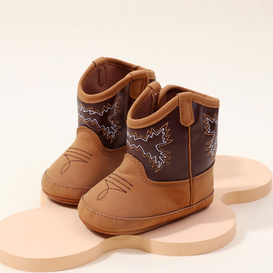 Denim-look PU leather baby boots with velcro closure and cowboy-style design, displayed on a light background.

