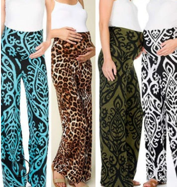 Woman wearing wide-leg maternity pants with high-waist elastic band, available in printed styles.