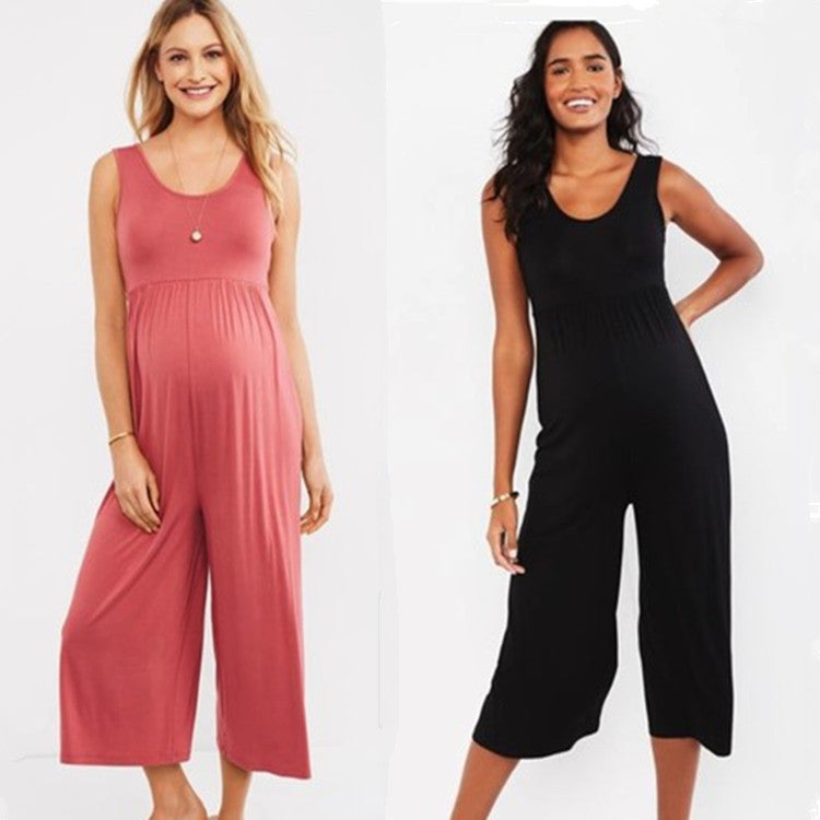Two pregnant women wearing black and pink cropped wide-leg maternity jumpsuits
